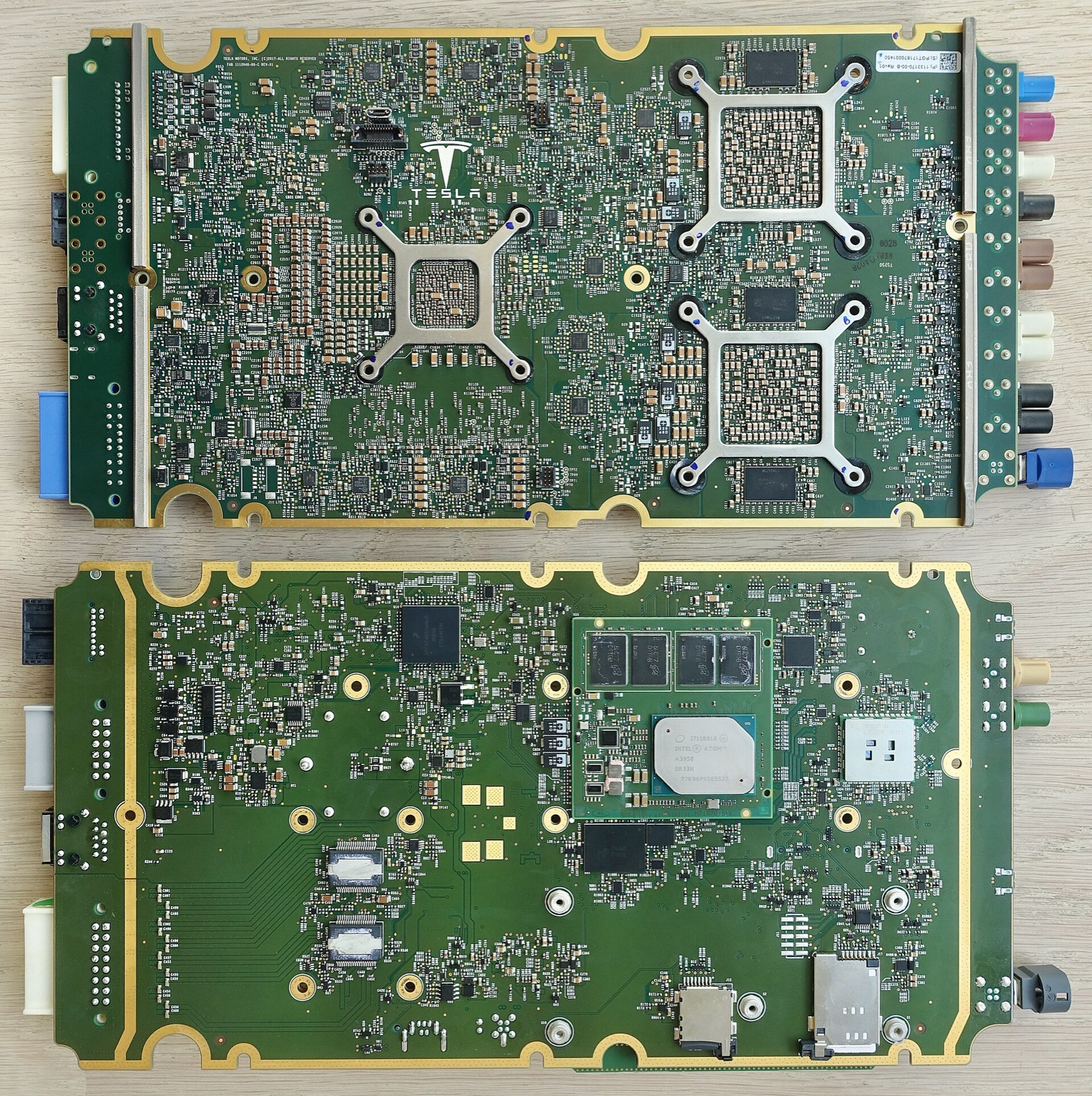 The Tesla HW 2.5 Autopilot and infotainment board, photographed from both sides — the kind of integrated compute board that lives behind every modern assisted-driving stack, including those running on chips like Horizon's Journey 6P and BYD's Xuanji A3. The scale of components and the multiple SoCs visible on a single PCB is what a one-stage end-to-end driving stack physically looks like. (Image: Wikimedia Commons, CC BY 2.0, Steve Jurvetson)