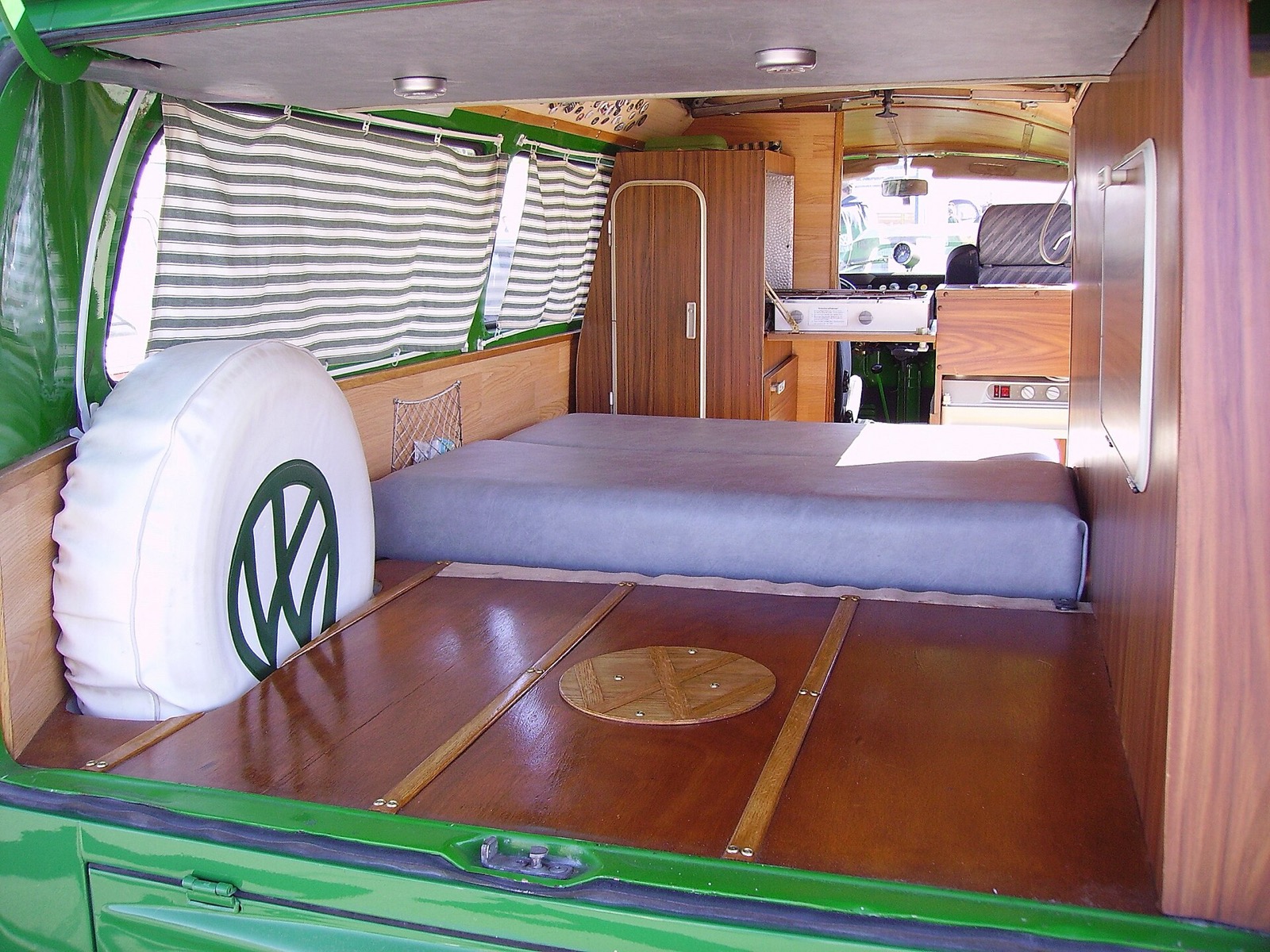 The classic answer to the question "can a car be a home" — a Westfalia-style fold-flat bed in the back of a Volkswagen Type 2 (T2) camper van. The 1960s T2 was the first mass-market car built around the idea that the cabin is also a bedroom. China's 2026 NEV boom is, in a sense, the first time a mass-market electric car has been designed around the same idea.